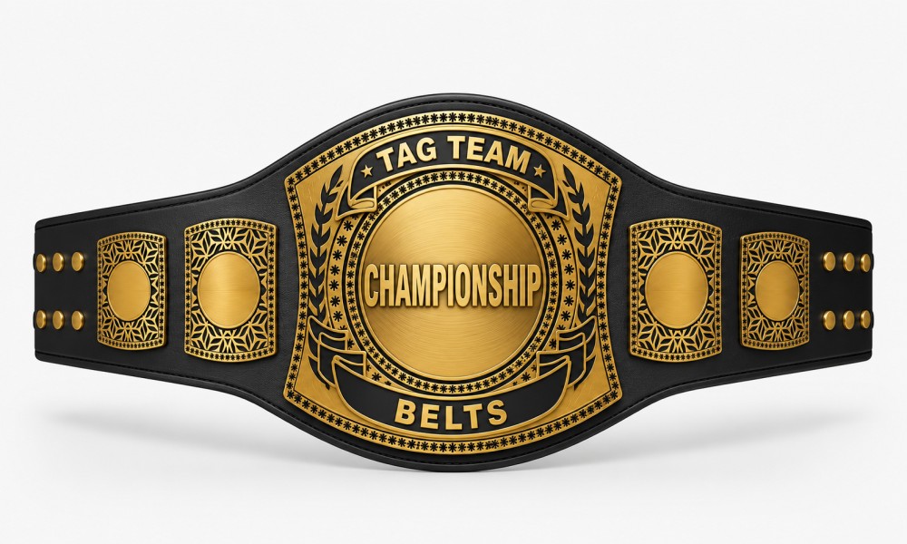 Premium black and gold Tag Team Championship belt with large central “CHAMPIONSHIP BELTS” plate and ornate side plates, displayed on a clean white background in a professional product showcase style.